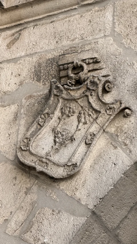 Escudo heráldico labrado (lado izquierdo del arco)