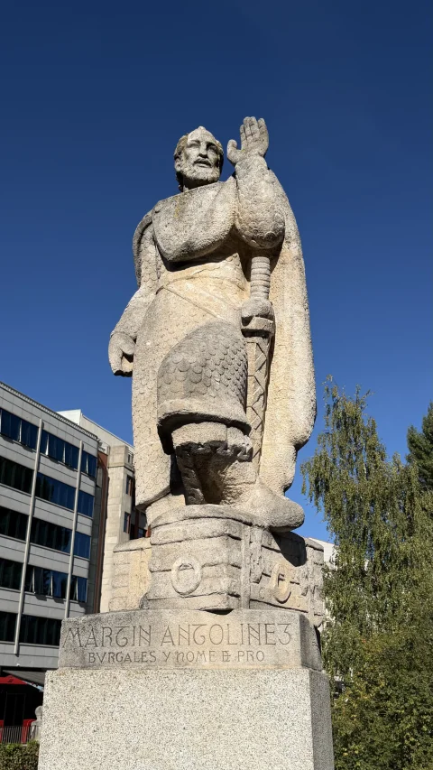 Estatua en piedra arenisca de Martín Antolínez («Bvrgales y nome de pro») con espada y mano alzada