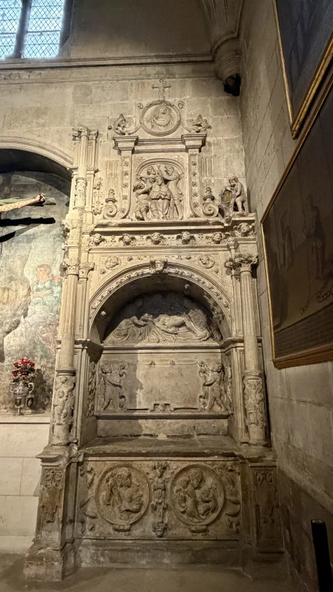 Arcosolio funerario plateresco labrado en piedra con relieves religiosos e inscripciones