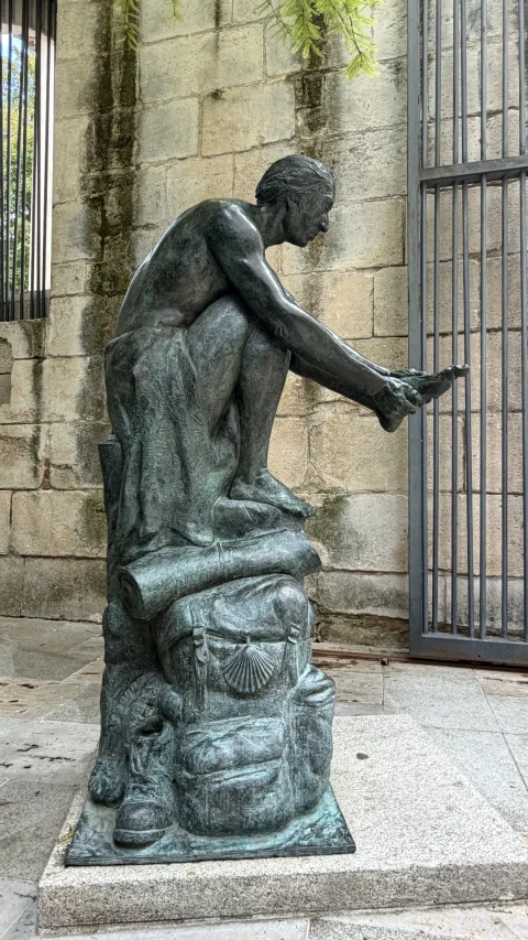 Detalle de la mochila y vieira en la Escultura del Peregrino
