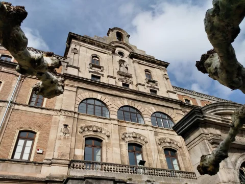 Vista en contrapicado de la fachada principal de piedra y espadaña de la Facultad de Teología del Norte de España en Burgos