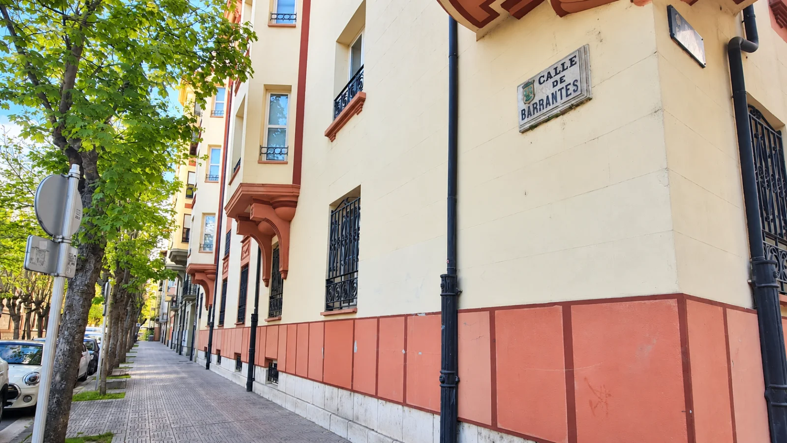 Placa de la calle Barrantes en Burgos, en la esquina de un edificio con balcones de forja