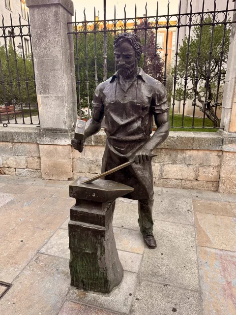Estatua del Herrero de Burgos: la figura de bronce con el martillo levantado sobre el yunque
