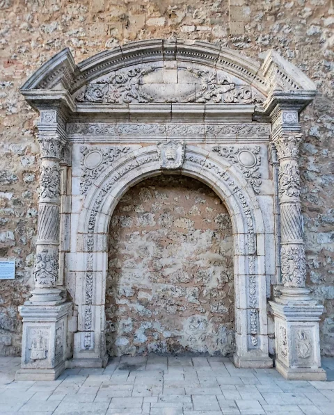 Portada renacentista con escudos y frontón partido en la iglesia del Monasterio de San Juan de Burgos